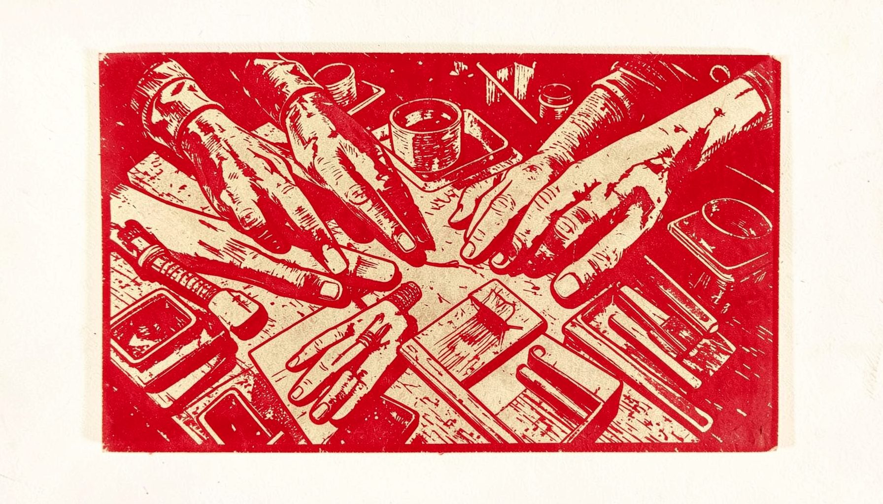 A linocut relief print of hands-on workshop materials spread across a table, warm sepia and slate tones, practical and learning-focused mood